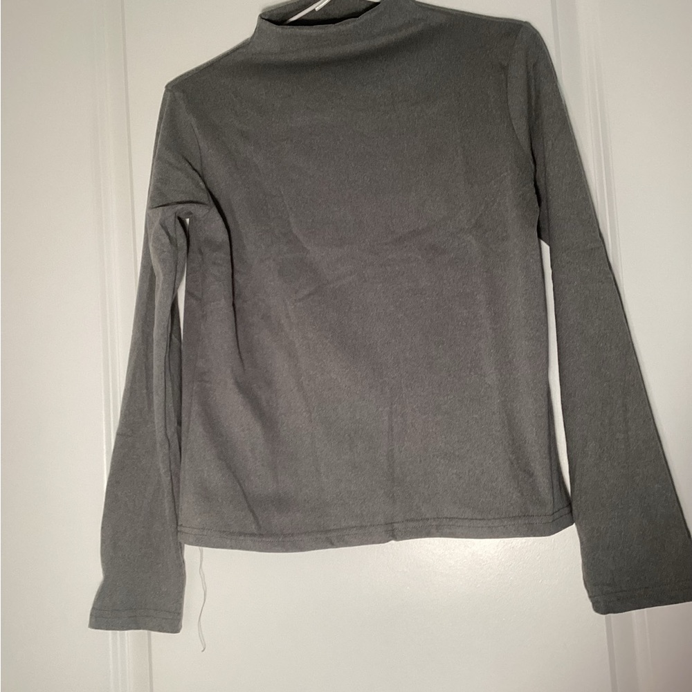 Stand up collar.  Thin material for layering.